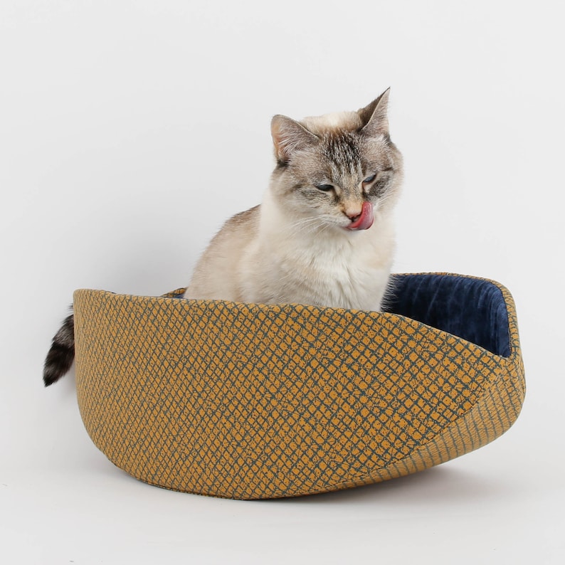 Our innovative Cat Canoe modern cat bed in a contrasting yellow and blue grid print with an unusual textured look. Our flexible beds are made with inner foam panels, are washable, and ready to ship. Fits cats to about 18 pounds, made in the USA.