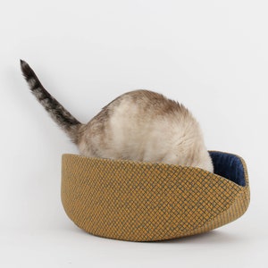 Our innovative Cat Canoe modern cat bed in a contrasting yellow and blue grid print with an unusual textured look. Our flexible beds are made with inner foam panels, are washable, and ready to ship. Fits cats to about 18 pounds, made in the USA.