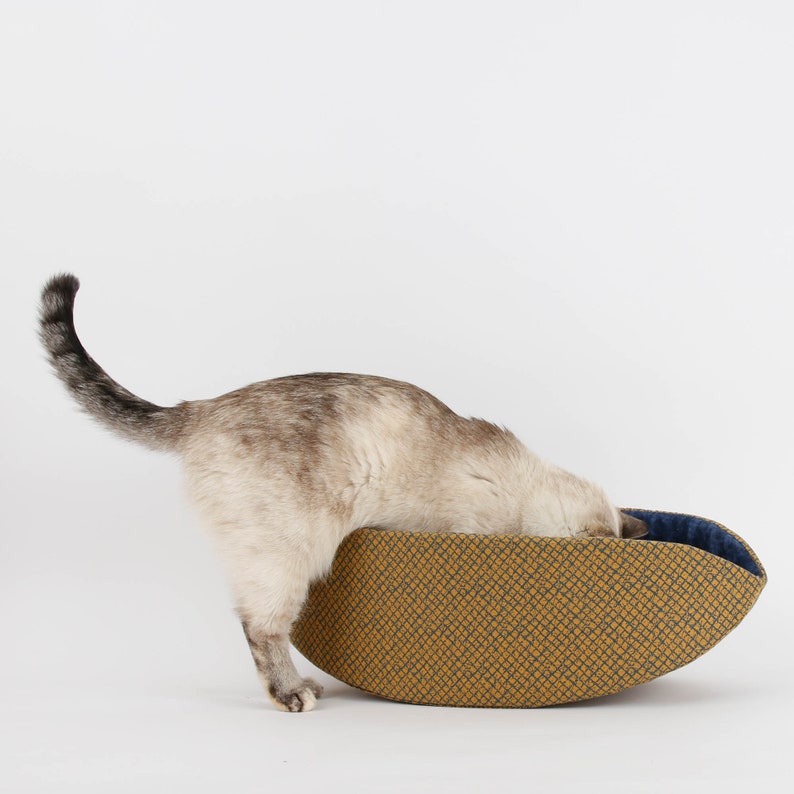 Our innovative Cat Canoe modern cat bed in a contrasting yellow and blue grid print with an unusual textured look. Our flexible beds are made with inner foam panels, are washable, and ready to ship. Fits cats to about 18 pounds, made in the USA.