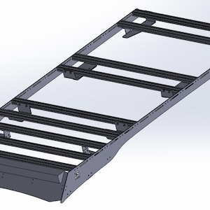 May include: A gray metal roof rack with multiple crossbars and a curved front section. The rack is designed for mounting on a vehicle and has a sturdy, industrial appearance.