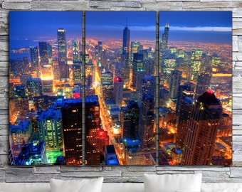 May include: A panoramic view of a city skyline at night. The city is lit up with lights, and the buildings are tall and modern. The sky is dark blue, and there are a few clouds in the distance.