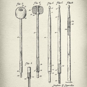 May include: A black and white line drawing of a patent for a drumstick. The patent is dated December 10, 1929, and the inventor is Abraham M. Zipperstein. The drawing shows different views of the drumstick, including the tip, the shaft, and the grip.
