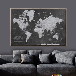 May include: A framed world map in shades of gray, with continents and oceans labeled. The map includes a compass rose and text that reads "The best things in life are the people we love, the places we've been, and the memories we've made along the way."