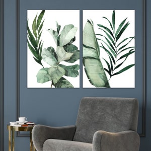 May include: Two watercolor paintings of tropical leaves. The first painting features a large green leaf with a lighter green center. The second painting features a cluster of smaller green leaves.