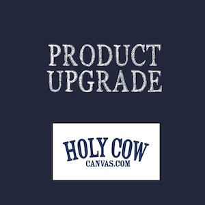 May include: Dark blue background with the words "PRODUCT UPGRADE" in white, distressed font. Below, a white rectangle contains the words "HOLY COW" in blue, stylized font, with "CANVAS.COM" below in smaller blue font.
