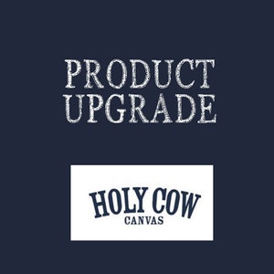 May include: White text on a dark blue background reads "PRODUCT UPGRADE". Below is a white rectangle with the text "HOLY COW CANVAS" in navy blue.