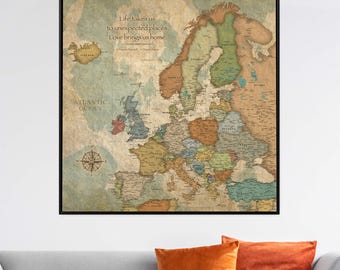 May include: A framed map of Europe with a vintage aesthetic. The map features various countries in different colors, with the Atlantic Ocean and a compass rose. Text at the top reads, "Life takes us to unexpected places. Love brings us home."