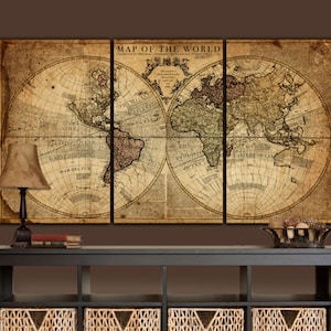 May include: A vintage-style world map print in three panels, featuring an antique-looking design with faded colors and text. The map is framed and displayed above a dark wooden console table with wicker baskets.