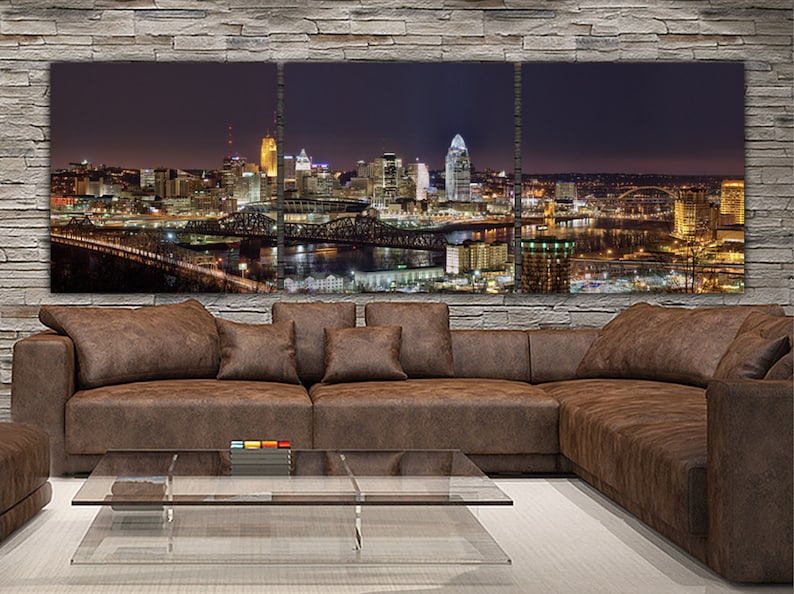 May include: A panoramic view of a city skyline at night. The city is lit up with lights, and there are several bridges in the foreground. The image is split into three panels.