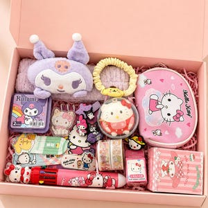 May include: A pink gift box filled with Hello Kitty themed items. Includes a plush Kuromi, a pink pencil case, a multi-color pen, erasers, stickers, hair accessories, and decorative tape. The box is lined with pink paper.