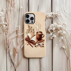 May include: A beige phone case with a sepia-toned illustration of a coffee cup, open book, glasses, and pencil. The design suggests a cosy reading theme, with steam rising from the coffee cup.