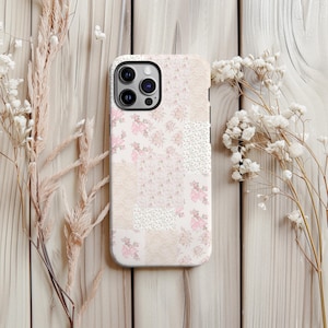 Peut inclure: Coque de téléphone à motifs patchwork roses, crème et blancs. Le motif comprend des motifs floraux et des textures, dont de la dentelle et des imprimés floraux délicats. Conçu pour un smartphone.