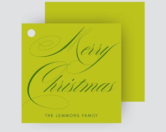 May include: A lime green Christmas gift tag with the words "Merry Christmas" in elegant green script. The text "THE LEMMONS FAMILY" is printed below. A hole is punched at the top left corner of the tag.