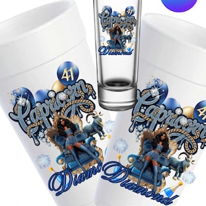 May include: White Capricorn cup template with a blue and gold design. The design includes the word "Capricorn" in a stylized font, a woman in a blue outfit, and the word "Diamond". A shot glass with the same design is also present.