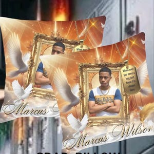 May include: Two decorative throw pillows featuring a portrait of a young man in a gold frame, with doves and an ethereal background. The pillows have the names "Marcus" and "Marcus Wilson" printed on them, along with the text "When ever you need a hug just know I'm always here."