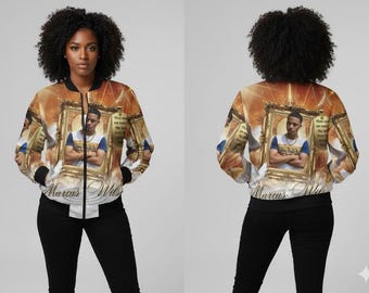 May include: A bomber jacket with a portrait design. The jacket features a portrait of a person in a gold frame, with the name "Marcus Wilson" printed on the front. The jacket has a white and black trim.