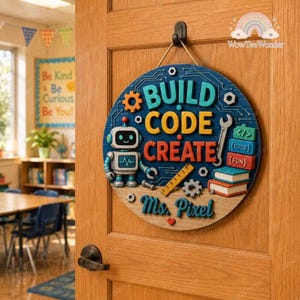 May include: A round wooden wall sign hanging on a door, featuring a blue background with circuit board patterns. It displays the text BUILD CODE CREATE in large letters, a robot illustration, a wrench, a ruler, and books labeled CODE and FUN.