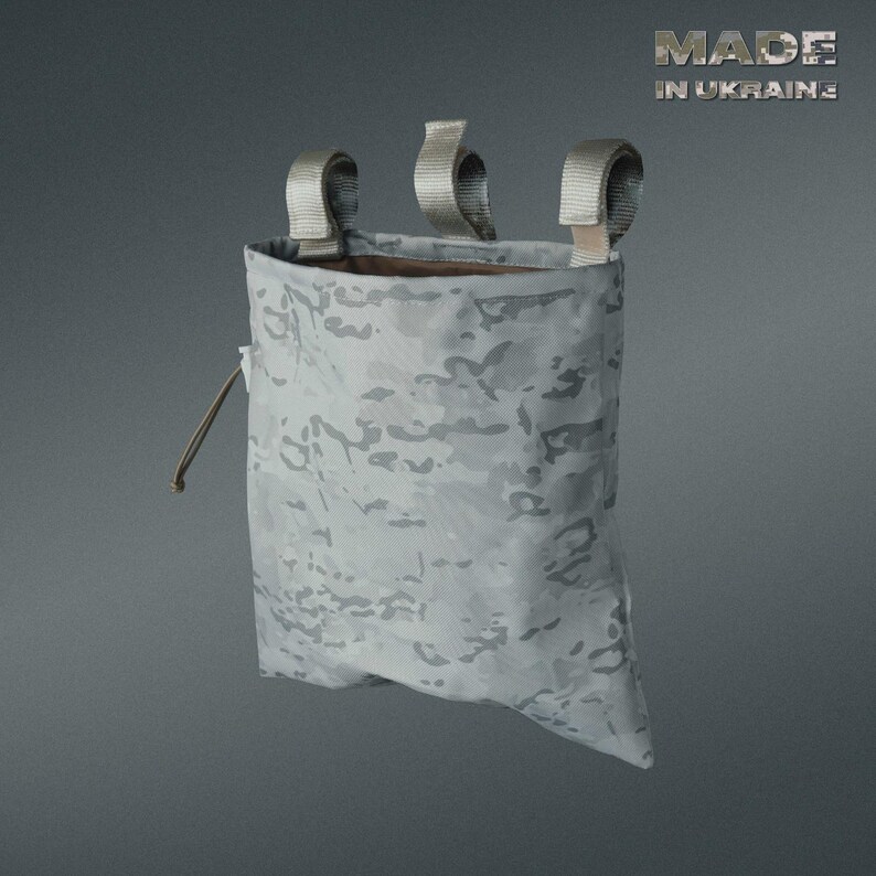 May include: A gray camouflage pouch with three loop straps at the top and a drawstring closure. The text "MADE IN UKRAINE" is visible in the upper right corner. The pouch is designed for carrying small items.