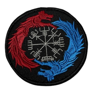 May include: Embroidered patch featuring a circular design with a red dragon on the left and a blue dragon on the right, surrounding a white rune symbol on a black background. The dragons are intertwined, creating a symmetrical pattern.