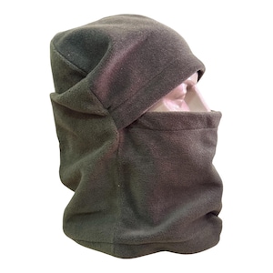 May include: An olive green fleece balaclava covering the head and neck, featuring a single large opening for the eyes and nose. The fabric has a soft, matte texture and provides full coverage for the upper face, chin, and neck area.