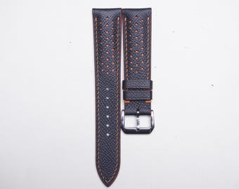 May include: Two black leather watch straps with orange stitching and a perforated design. The straps feature a stainless steel buckle. The straps are displayed on a white background.