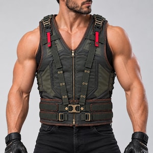 May include: A dark olive green tactical vest featuring a central zip, adjustable shoulder straps with red accents, and a wide waist belt with a metallic buckle. The vest includes side lacing, reinforced stitching, and multiple brass-toned eyelets.