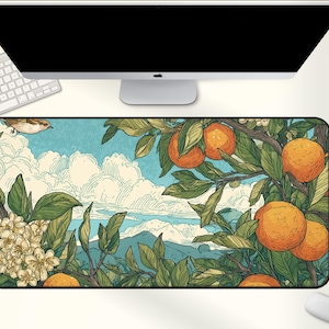 May include: A rectangular desk mat featuring a vibrant illustration of an orange tree with ripe oranges, green leaves, and white blossoms against a blue sky with clouds. A bird is flying above the tree. The mat is placed under a computer monitor and keyboard.