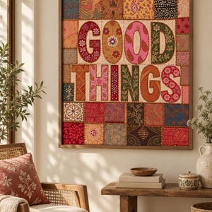 May include: A rectangular wall art piece featuring a patchwork of various fabric squares in shades of red, orange, pink, and brown. The center displays the text GOOD THINGS in large, embroidered, multi-colored fabric letters with floral patterns.