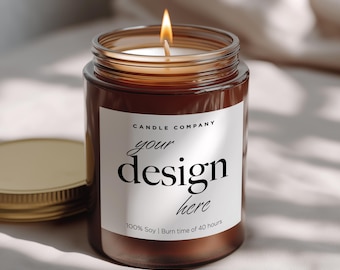 May include: A lit soy candle in a brown glass jar with a gold lid. The label reads "Candle Company" and "your design here". The candle has a burn time of 40 hours.