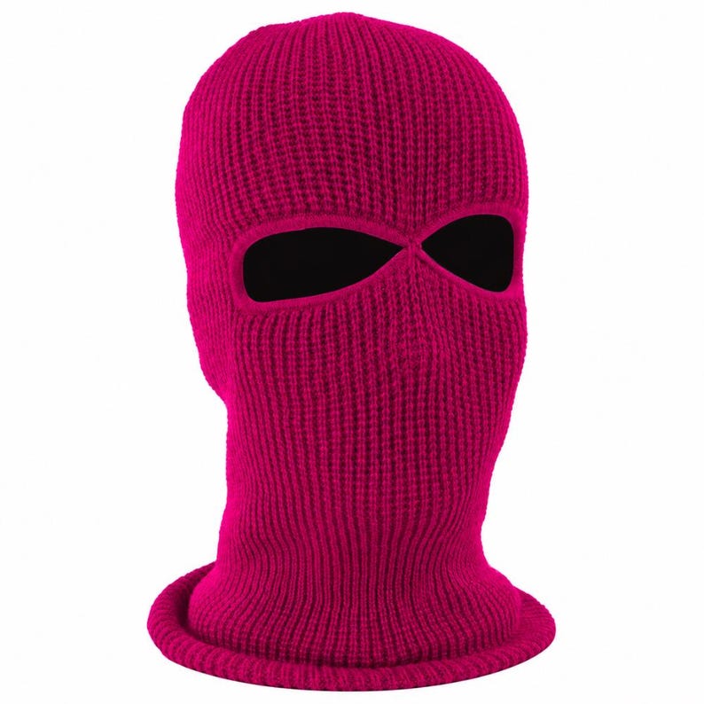 K&ouml;nnte beinhalten: Eine leuchtend pinkfarbene Strick-Balaclava mit zwei Augen&ouml;ffnungen. Die Skimaske besteht aus einem Rippstrickstoff und hat einen gerollten Saum am unteren Rand. Die Augen&ouml;ffnungen sind schwarz.