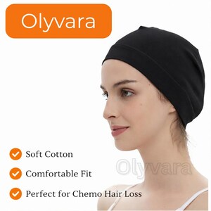 May include: A black cotton cap, designed for comfort, is worn by a person. The cap is part of the Olyvara brand. The image includes text indicating the cap is soft, comfortable, and suitable for chemo hair loss.