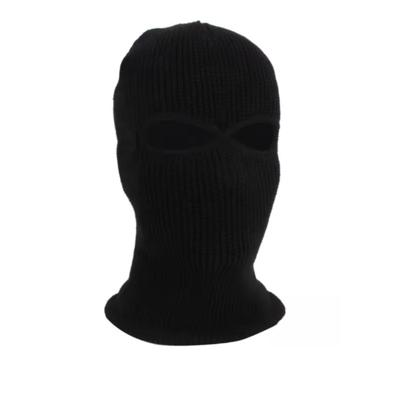 K&ouml;nnte beinhalten: Eine schwarze Strick-Balaclava mit Augen- und Mund&ouml;ffnungen. Die Kopfbedeckung besteht aus einem Rippstrickstoff und ist so konzipiert, dass sie Kopf und Hals bedeckt. Die Sturmhaube ist einfarbig schwarz.