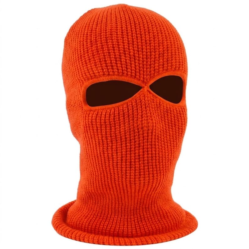 K&ouml;nnte beinhalten: Leuchtend orangefarbene Strick-Balaclava mit zwei Augen&ouml;ffnungen. Die Kopfbedeckung besteht aus einem Rippstrickgewebe und ist so konzipiert, dass sie Kopf und Hals bedeckt. Die Sturmhaube ist einfarbig und hat einen gerollten Rand am Hals.