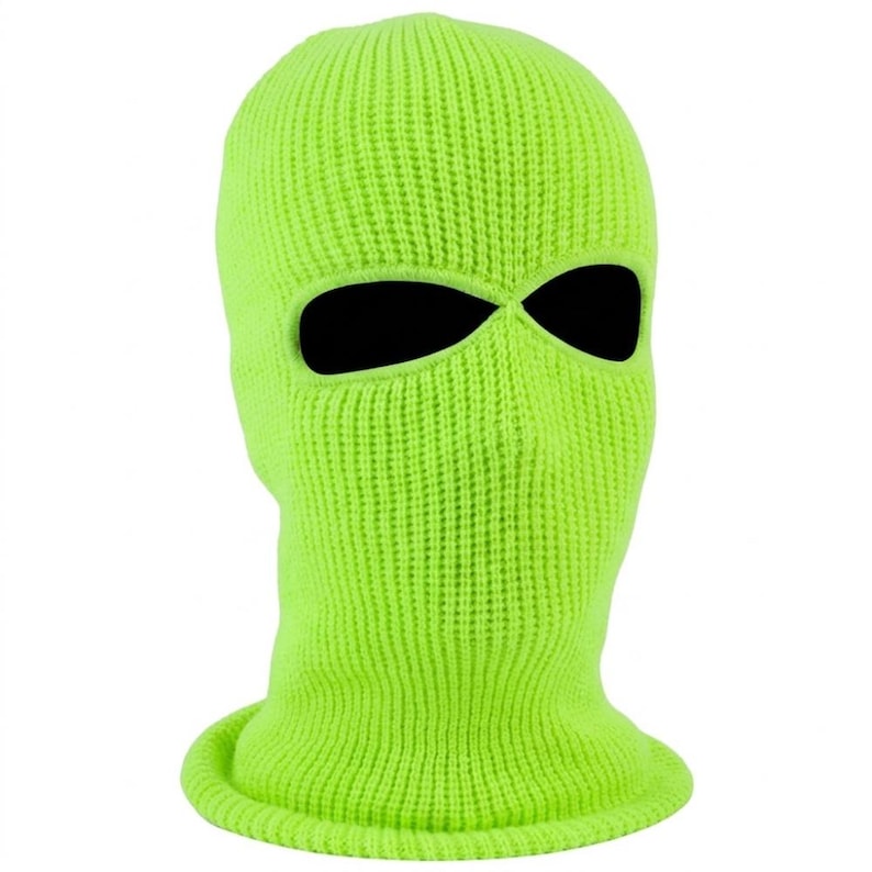 K&ouml;nnte beinhalten: Eine neongr&uuml;ne Strick-Balaclava mit schwarzen Augen- und Mund&ouml;ffnungen. Die Skimaske besteht aus einem Rippstrick und hat einen gerollten Saum am unteren Rand.