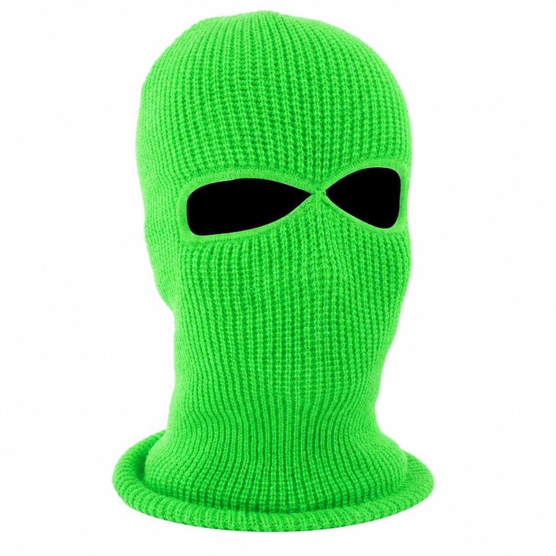 K&ouml;nnte beinhalten: Leuchtend gr&uuml;ne Strick-Balaclava mit Augen- und Mund&ouml;ffnungen. Die Skimaske bedeckt den gesamten Kopf und Hals, mit einem gerippten Saum am unteren Rand. Die leuchtende Farbe und der enge Sitz deuten auf ein Winteraccessoire oder ein Kost&uuml;mteil hin.
