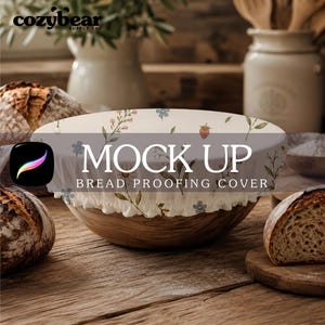 May include: A round bread proofing cover with an elasticized edge, featuring a cream-colored fabric printed with small blue flowers, green stems, and red strawberries. The text MOCK UP BREAD PROOFING COVER is centered on the fabric surface.