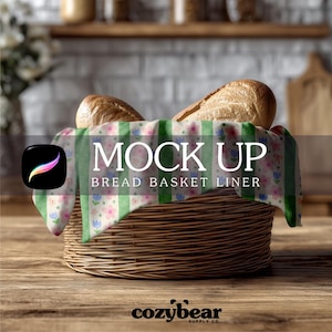 May include: A woven wicker bread basket with a floral and green striped liner, holding two loaves of bread. The words "MOCK UP" and "BREAD BASKET LINER" are displayed on the liner. The Cozybear Supply Co. logo is at the bottom.