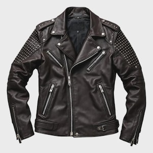 May include: A dark brown leather jacket with silver zips and studded detailing on the shoulders and sleeves. The jacket has an asymmetrical zip closure, multiple pockets, and a notched collar. A classic biker-style jacket.
