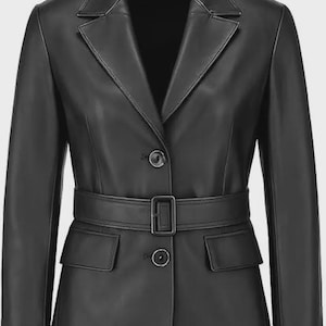 May include: A black leather blazer with a notched collar, two front pockets, and a belt with a rectangular buckle. The blazer has a two-button closure and long sleeves. The overall style is classic and tailored.