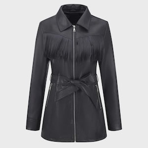 May include: Black leather jacket with fringe detail across the chest. The jacket features a zip-up front, a belted waist, and long sleeves. The jacket has a classic collar and two zippered pockets.