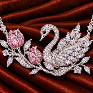 May include: A silver-toned necklace featuring a central swan pendant encrusted with clear pavé crystals and a black eye accent. To the left, two pink crystal tulips with green-toned leaves are attached, all adorned with sparkling clear stones.