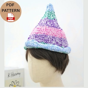 May include: A colorful, handmade crochet hat with a pointed top. The hat features a mix of pink, purple, green, and blue yarn. The brim is light blue. The image also includes a PDF pattern icon.