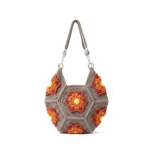 May include: A handmade crochet bag with a geometric design. The bag features a gray body with orange and yellow floral accents. The handles are gray and attached with silver chains and blue beads.