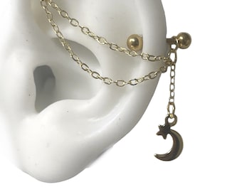 May include: Gold ear cartilage barbell with a double chain and a crescent moon charm with a star.