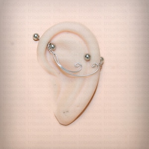 Industrielles Bijoux-Piercing mit Ornament und unbrennbarem Faden