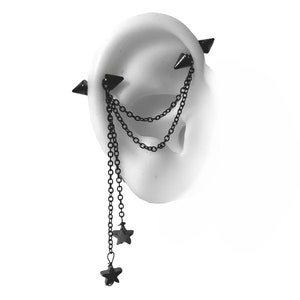 May include: Black ear cuff with a chain and star charms. The chain is attached to two black spikes that are inserted into the ear.