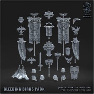May include: A collection of grey resin miniature gaming components including two large banners with eagle motifs, a sword, a battle axe, a war hammer, a cape, various shields, and shoulder pauldrons. The text reads BLEEDING BIRDS PACK and HYDRA WORKSHOP.