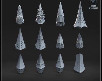 May include: A collection of gray, pointed helmets with various designs, including crosses, spikes, and face details. The helmets are arranged on a dark background. Text at the bottom reads "FANATICS HELMETS".