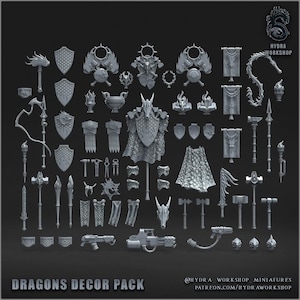 May include: A collection of grey miniature gaming accessories including shields, banners, weapons, and dragon-themed armor pieces. The set features various sculpted items like hammers, spears, and capes, labeled as Dragons Decor Pack by Hydra Workshop.