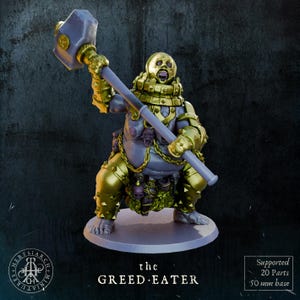 May include: A detailed miniature figure of "the GREED EATER" with a large hammer. The figure is primarily gold and gray, with intricate armor and a grotesque face. The base is 50 mm. The figure is supported by 20 parts.